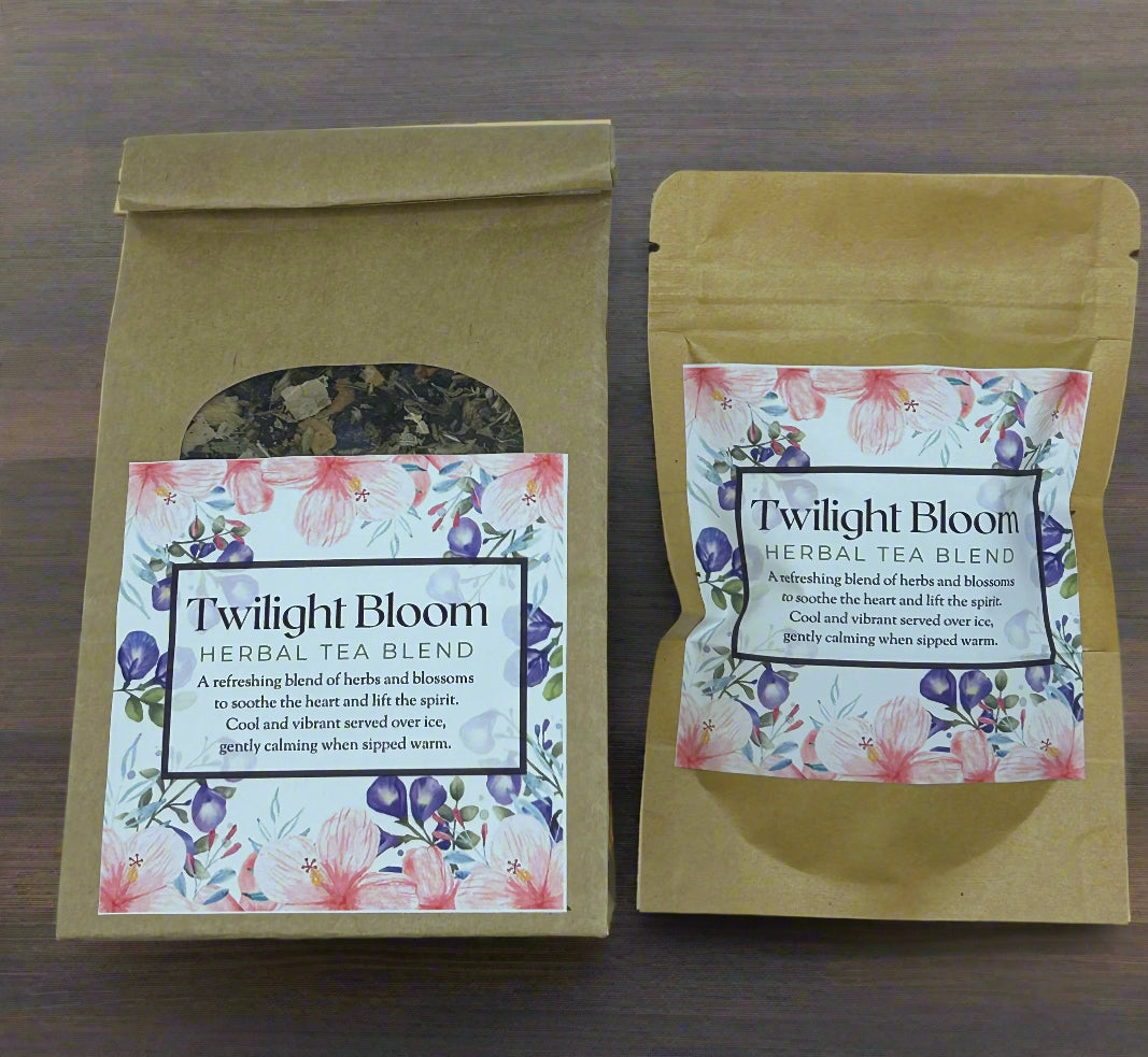 Two packages of Twilight Bloom herbal tea blend with decorative labels on a wooden surface.