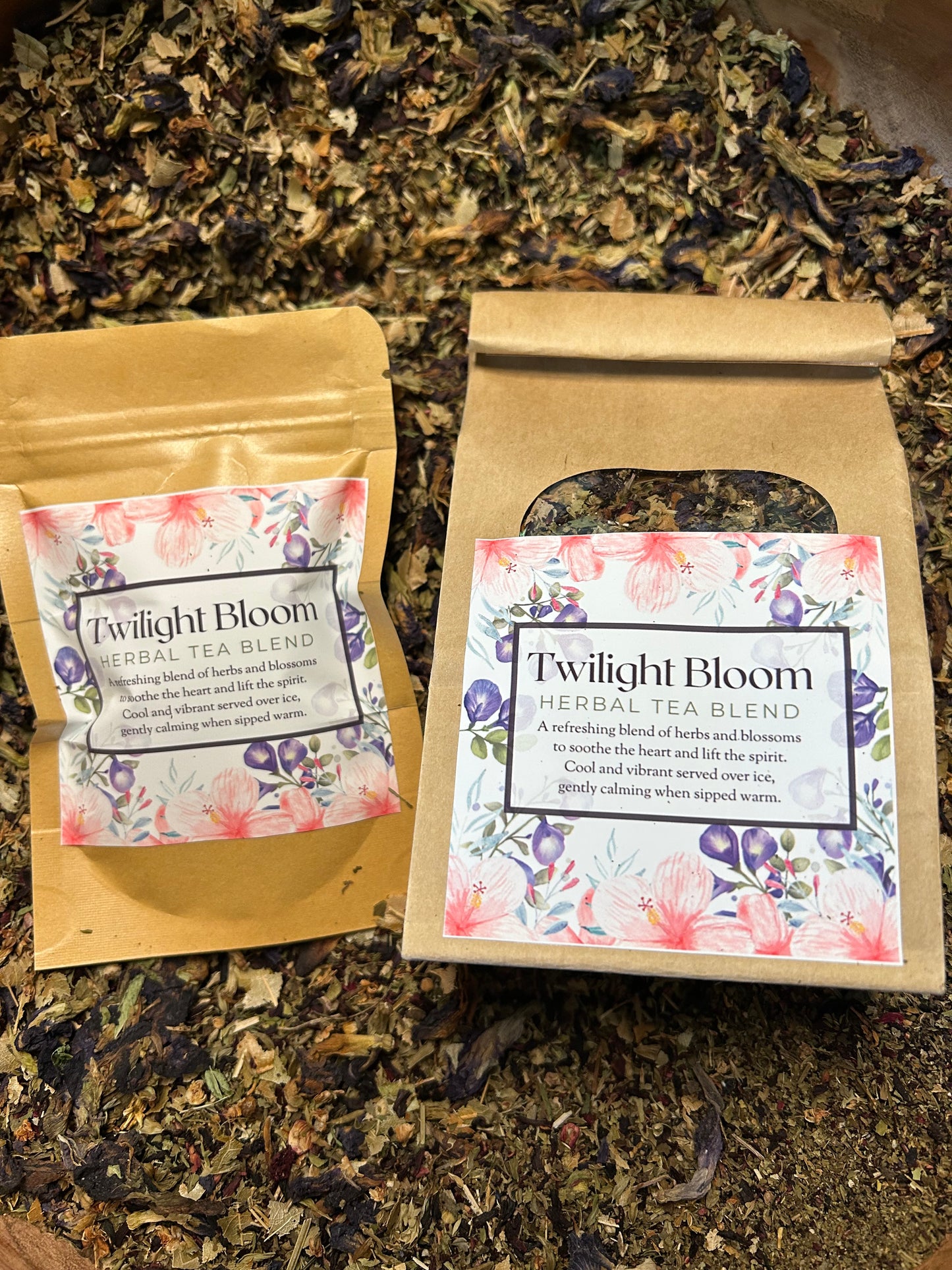 Tea packaging labeled 'Twilight Bloom' on a bed of loose tea leaves.